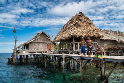 Small kids playing a song in a fishing village in Raja Amat, Papua