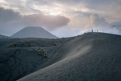 Man with his horse on the sand savanna of Mt Bromo, East Java