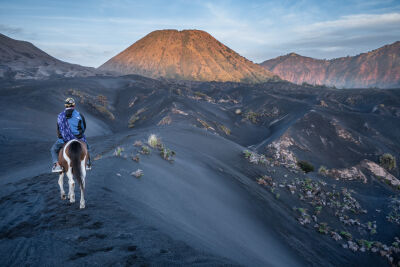Horse rider in the Bromo volcano landscape
