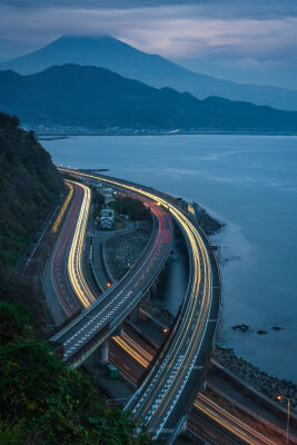 Cars and trains passing by Mt Fuji in Japan