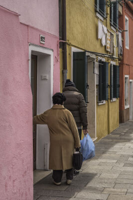 Locals coming out of their house in Burano, Italy